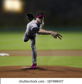 Pitcher Baseball Player on a Pink Uniform on baseball Stadium.