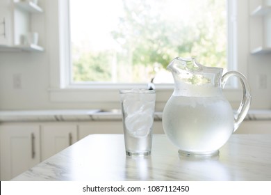 A Pitcher And Glass Of Ice Water