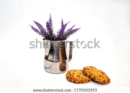 Pitcher milkman steel. lavender and spicy oatmeal cookies on a white background