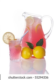 Pitcher Of Pink Lemonade With Glass And Whole Lemons