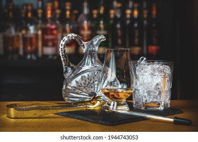 Pitcher with water, ice and a glass of whisky
