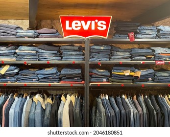 PITIGLIANO, ITALY - Sep 04, 2021: Levis Logo And Clothing On Hangers In A Store