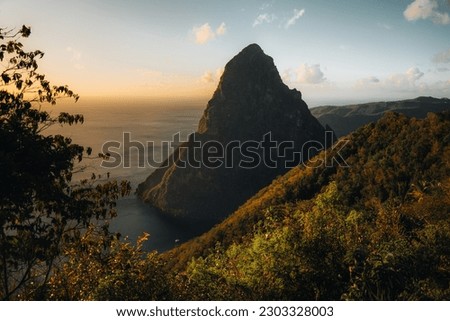 Pitons on Santa Lucia, La Souffriere bay during sunset with blue sky and cotton candy clouds. Caribbean Island. Vieux Fort, Saint Lucia. Travel and honeymoon concept.