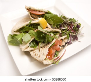 Pitta Bread Filled With A Tuna Salad On A White Plate.