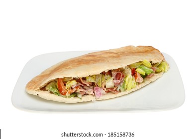 Pitta Bread Stuffed With Crispy Bacon And Salad On A Plate Isolated Against White