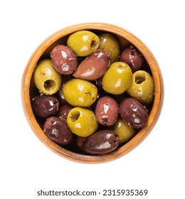 Pitted Kalamata and green olives, in a wooden bowl. Mix of organic Greek olives, green and black, with herbs, preserved in native olive oil. Popular table olives, used as snack, appetizer or garnish. - Powered by Shutterstock