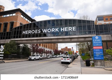 Pittsburgh, PA / USA -  04 21 2020: Heroes work here display on University of Pittsburgh Medical center hospital air bridge