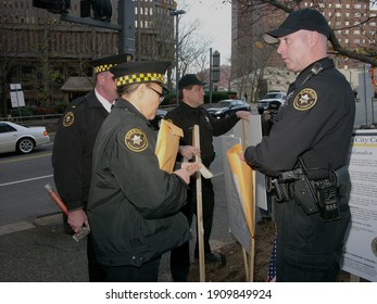 Pittsburgh, PA USA. December 13, 2011. Group Of Sheriffs For Allegheny County Putting Signs In The Ground In Downtown Pittsburgh Pennsylvania.