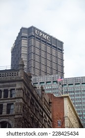 Pittsburgh, PA, USA - January 16, 2014: A Flag Flaps In The Wind Beneath The University Of Pittsburgh Medical Center Hospital Tower On A Winter Day.