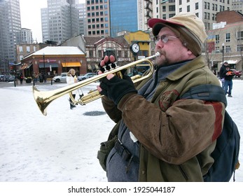 Pittsburgh, PA USA. January 20, 2012. Older Man Playing The Trumpet In A Snowy Open Space In Downtown Pittsburgh Pennsylvania.