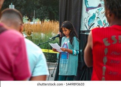 Pittsburgh, Pennsylvania / United States - 7-12-19: A Young Latinx Girl Reads A Poem To The Crowd At The Lights For Liberty Vigil