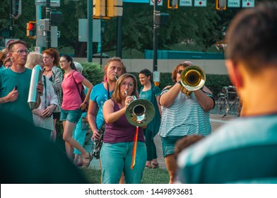 Pittsburgh, Pennsylvania / United States - 7-12-19: Two Women Play Instruments For The Crowd At The Lights For Liberty Vigil