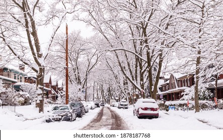 Pittsburgh, Pennsylvania, USA 12-17-20 Cars parked along snowy streets in the Regent Square neighborhood of the city on a winter day