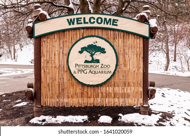 Pittsburgh, Pennsylvania, USA 2/9/20 The Pittsburgh Zoo sign at the front entrance on a winter day with snow in the background