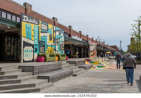 Pittsburgh, Pennsylvania, USA April 30,\
2022 People walking along Smallman Street in front of the Terminal\
in the Strip District neighborhood on a spring\
day