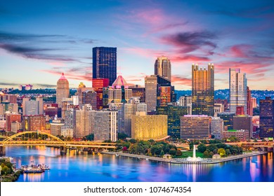 Pittsburgh, Pennsylvania, USA Downtown City Skyline On The Rivers At Dusk.
