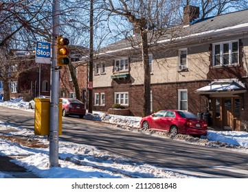 Pittsburgh, Pennsylvania, USA January 21, 2022 A traffic light at a bus stop in an intersection in the Squirrel Hill neighborhood on a sunny winter day