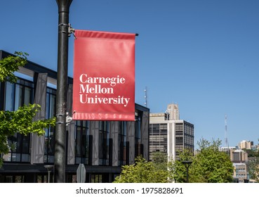 Pittsburgh, Pennsylvania, USA- May 13, 2021: Carnegie Mellon University campus entrance sign with buildings in the background.  CMU is a private research university