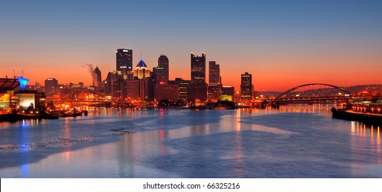 Pittsburgh Skyline At Night:  A View Of Pittsburgh At Night Overlooking Pittsburgh's Three Rivers (Allegheny, Monongahela, And Ohio), The Fort Pitt And Fort Duquesne Bridge, And Point State Park.