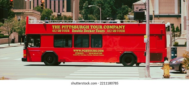 PITTSBURGH, UNITED STATES - Jun 28, 2021: A Red Tour Bus Driving Across The Road