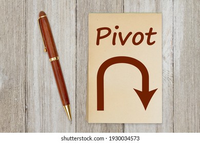 Pivot Message With Arrow On Retro Old Yellowed Paper Notepad With A Pen