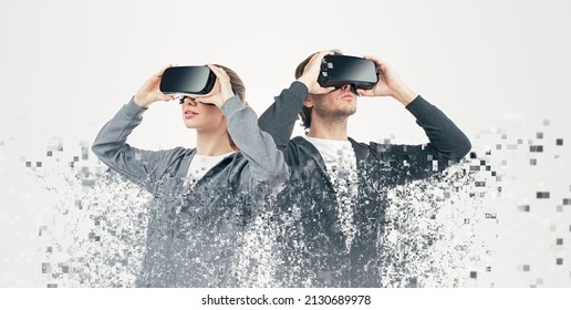 Pixelated shot of man and woman exploring virtual reality and immersing into cyberspace on white background in studio - Powered by Shutterstock