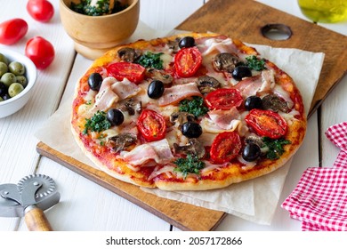 Pizza with bacon, mushrooms, tomatoes, cheese and olives. Italian food