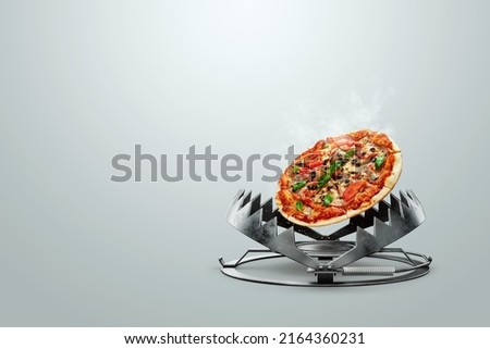 Pizza in a bear trap, close-up. The concept of gluttony, obesity, fast food, addiction, malnutrition