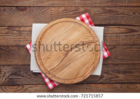 Pizza board and tablecloth on wooden table. Top view mock up