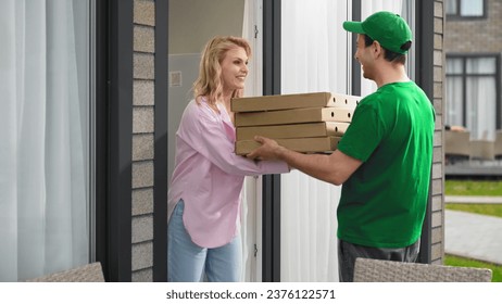 Lot pizza box deliver. Man give many hot pie. Fast food delivery service. Joy girl meet pizzeria courier. Young adult person order take away meal. Tasty pizza home delivery. Online city eat cafe job. - Powered by Shutterstock