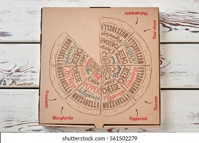 Pizza box on wooden background. Closed pizza cardboard case. Convenient way of delivery.