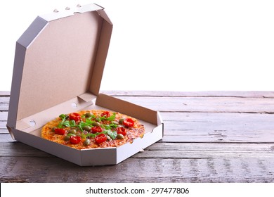 Pizza In Box On Wooden Table Isolated On White