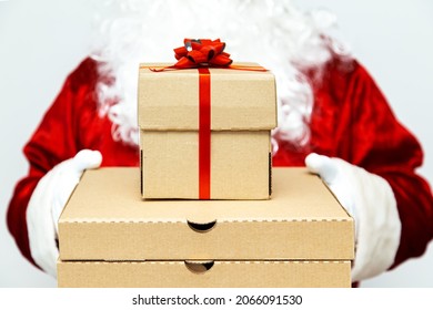 Pizza Boxes And A Gift In The Hands Of Santa Claus.  Christmas Fast Food Delivery.  New Year's Eve Promotion.