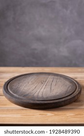 Pizza Or Bread Cutting Board For Homemade Baking On Wooden Table Near Grey Wall. Food Recipe Concept At Wood Background Texture With Copy Space. Front View