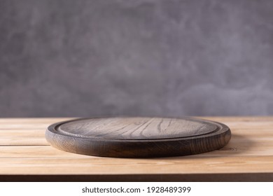 Pizza Or Bread Cutting Board For Homemade Baking On Wooden Table Near Grey Wall. Food Recipe Concept At Wood Background Texture With Copy Space. Front View