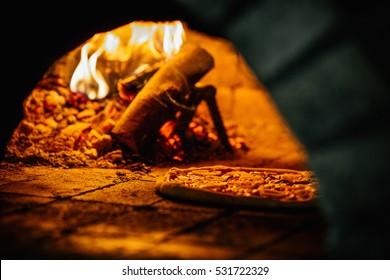Pizza and brick pizza oven with fire