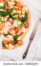 Pizza With Cauliflower Base, Chicken, Ruccola Leaves, Cherry Tomatoes And Mozzarella Cheese On White Background Top View

