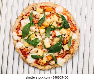 Pizza With Cauliflower Base, Chicken, Ruccola Leaves, Cherry Tomatoes And Mozzarella Cheese On White Background Top View

