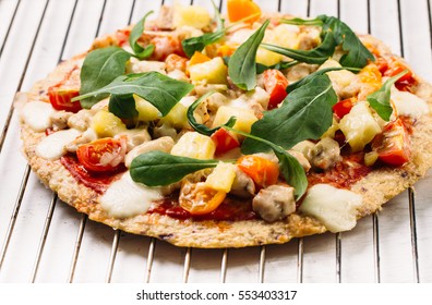 Pizza With Cauliflower Base, Chicken, Rucola Leaves, Cherry Tomatoes And Mozzarella Cheese On White Background Top View
