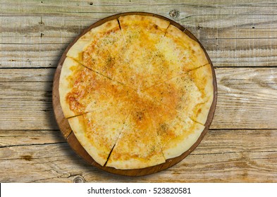 Pizza With Cheese Without Meat On A Wooden Base