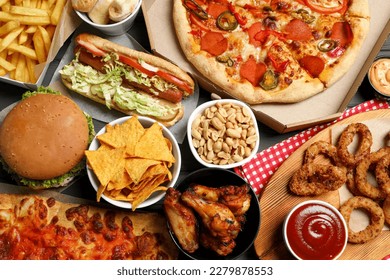 Pizza, chips and other fast food as background, top view - Shutterstock ID 2279878553