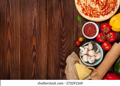 Pizza cooking ingredients. Dough, vegetables and spices. Top view with copy space