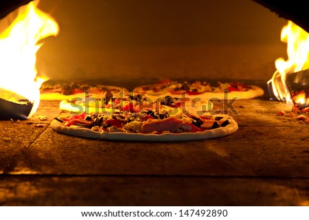 Pizza cooking in a tradition oven