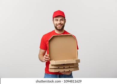 Pizza delivery concept. Young boy is delivering and showing pizza boxs in boxes. Isolated on white background - Powered by Shutterstock