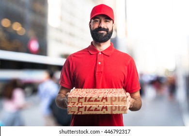 Pizza delivery man on unfocused background
