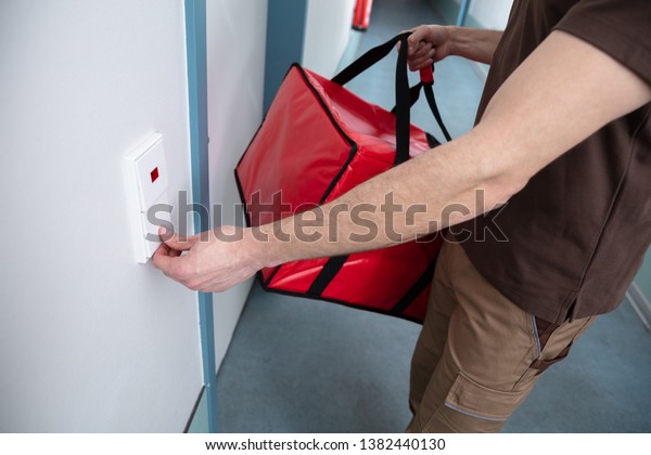 Pizza Delivery Man Ringing Door Bell Stock Photo Edit Now 1382440130