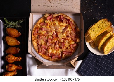 Pizza Delivery Service In A Cardboard Box With Cheese Garlic Bread And New Orleans Wings