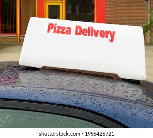 PIZZA DELIVERY Sign Mounted On Roof Of Car With Raindrops. Copy Space.