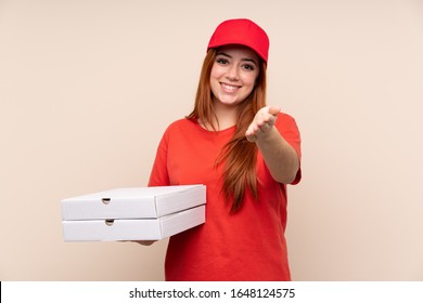 Pizza Delivery Teenager Girl Holding A Pizza Over Isolated Background Handshaking After Good Deal