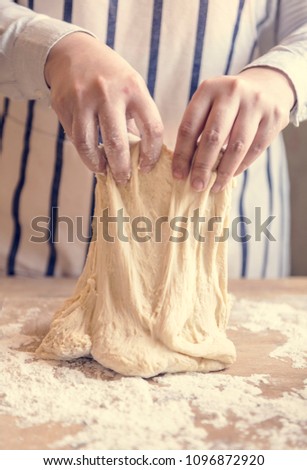 Similar – woman kneading bread dough with her hands